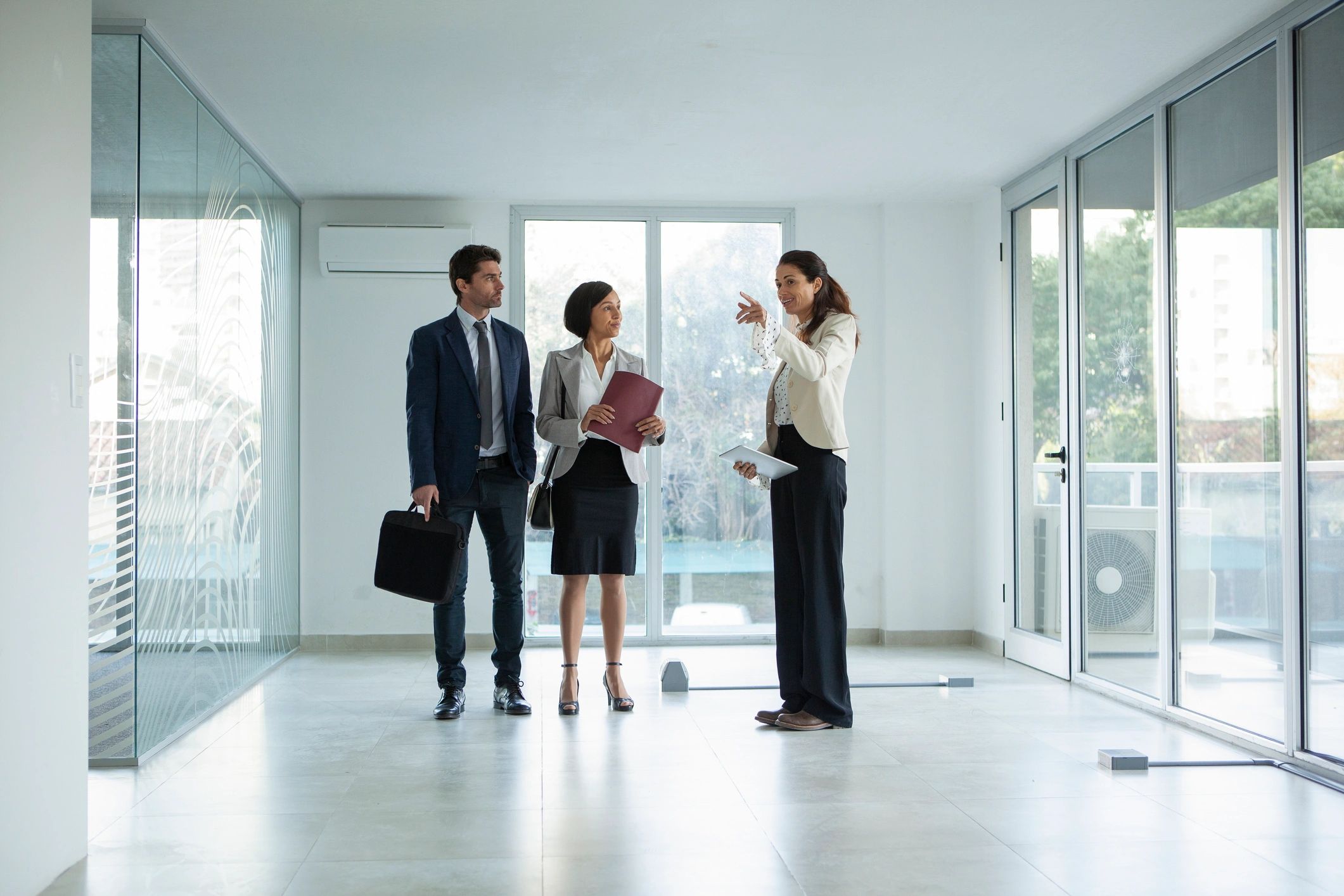 Real estate professional with clients in an office