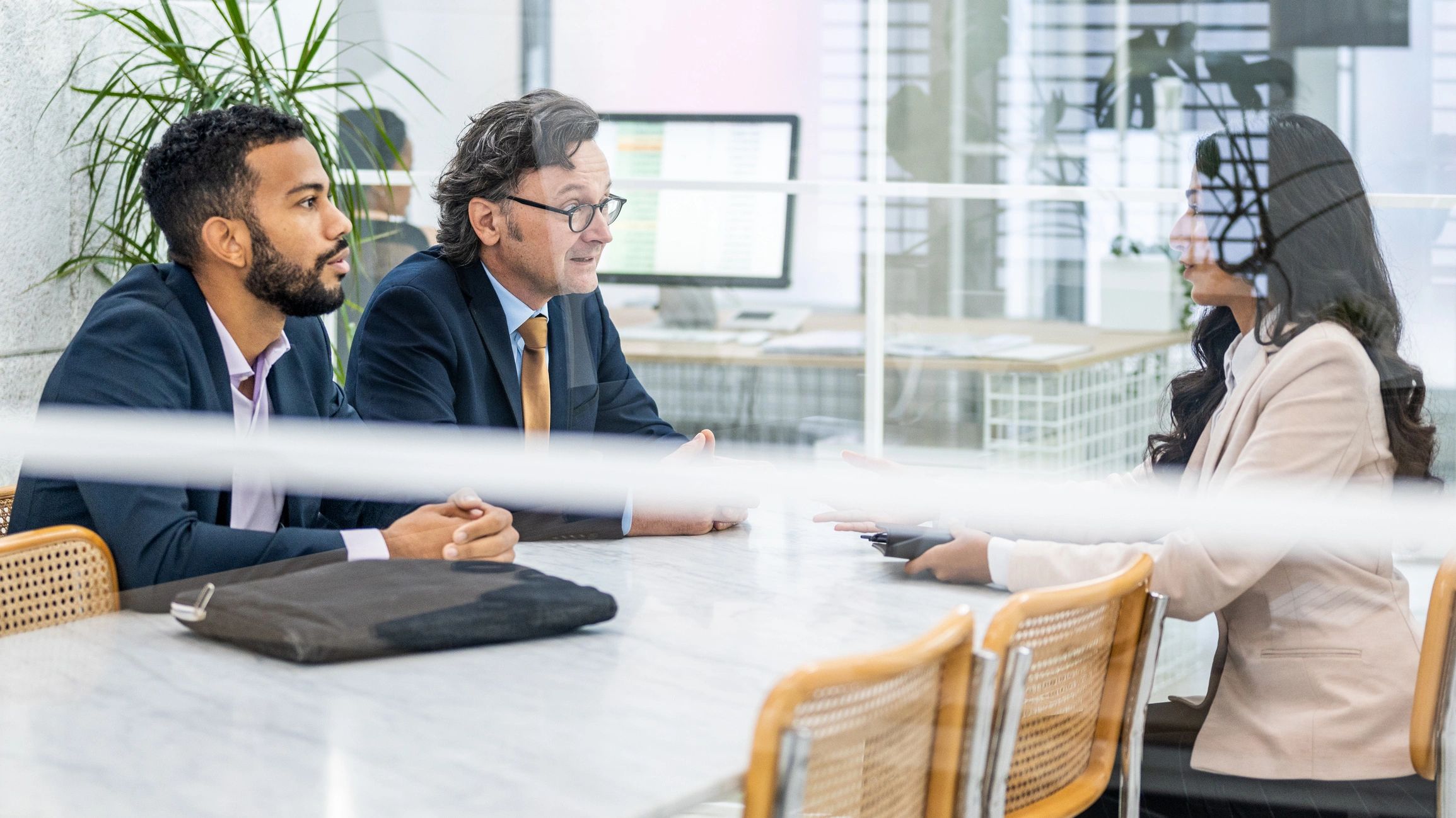 Business professionals discussing an agreement in a meeting room