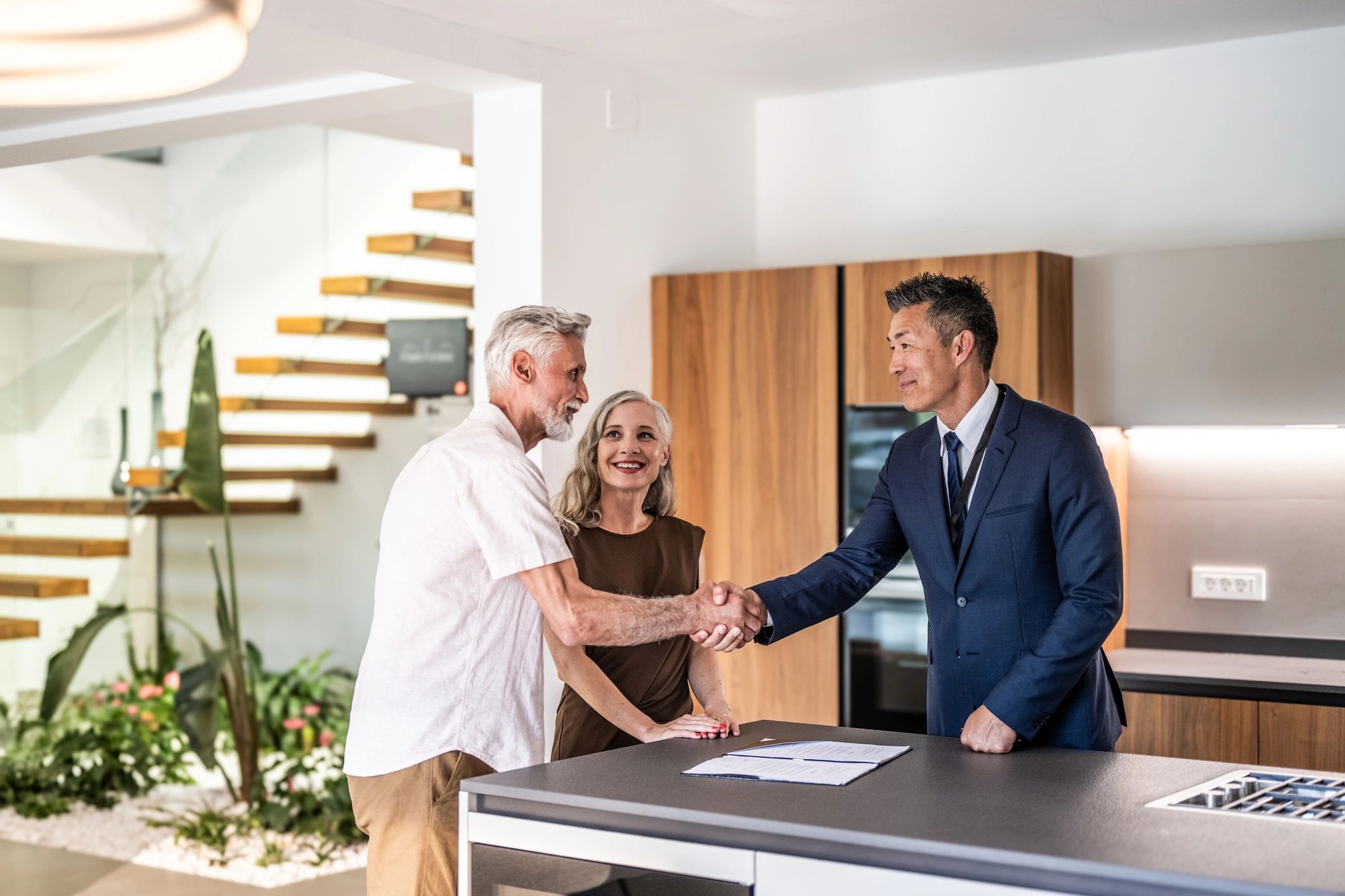 Clients reviewing real estate paperwork with an advisor