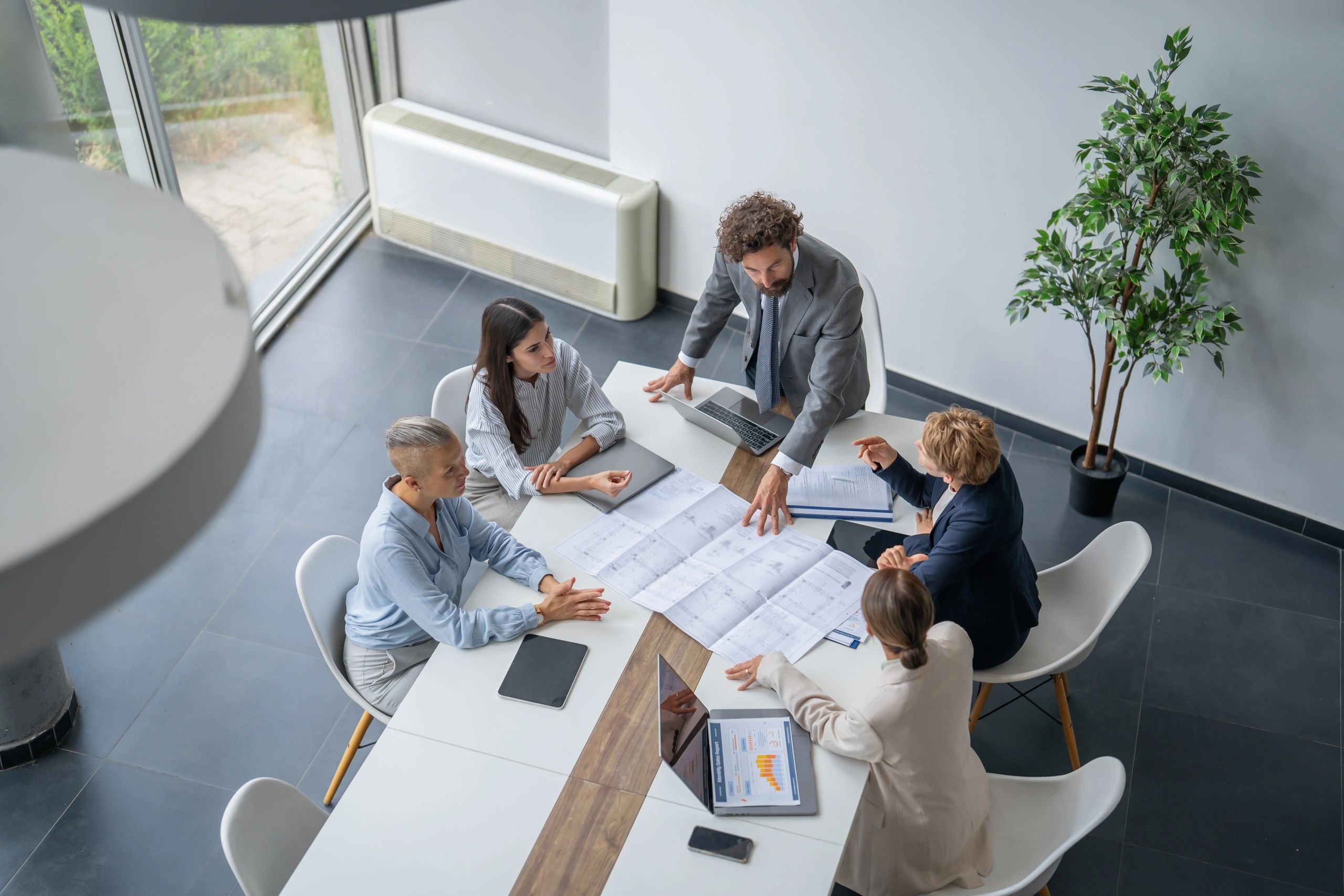 Team reviewing blueprints in a modern office
