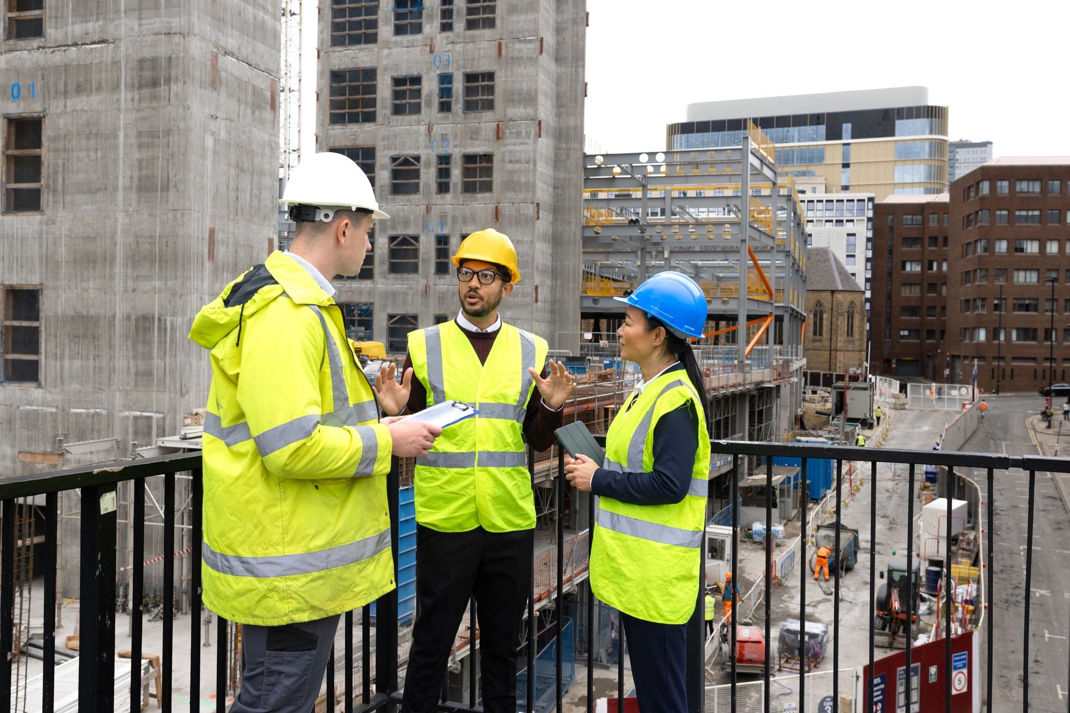 Construction team discussing blueprints at a job site